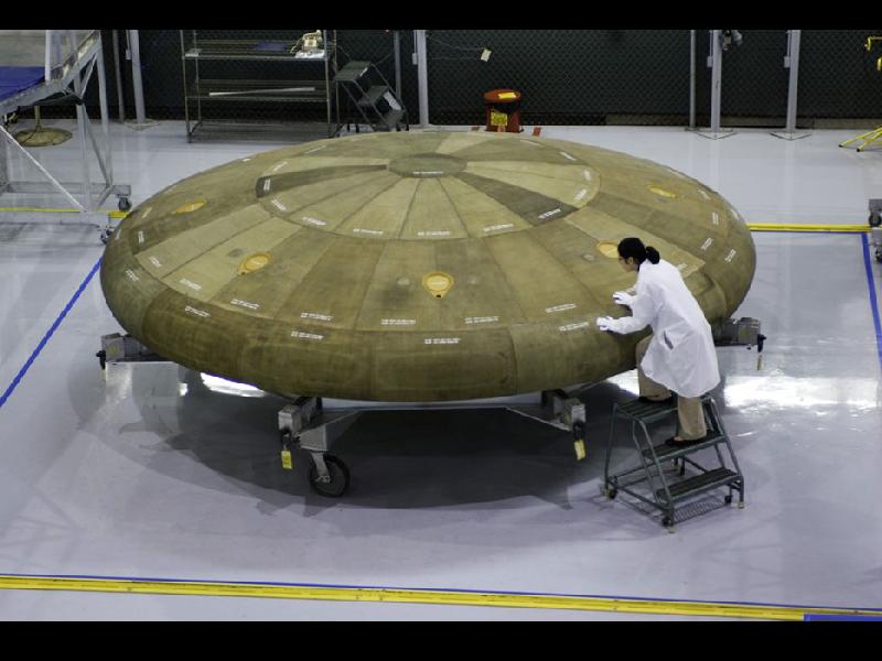 A Boeing engineer inspects a heat shield for the Orion crew capsule on Constellation, the next step in NASAs launch systems for near-Earth access. Courtesy Boeing, Joe Olmos/NASA.